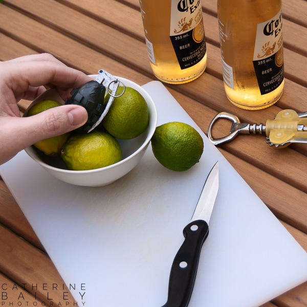 Fake hand grenade in bowl of limes | Catherine Bailey Photography