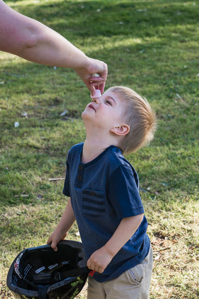 Boy balancing marshmallow on nose