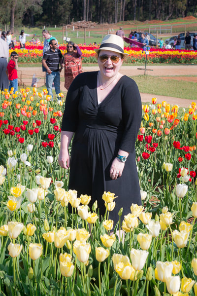 Woman laughing in field of tulips
